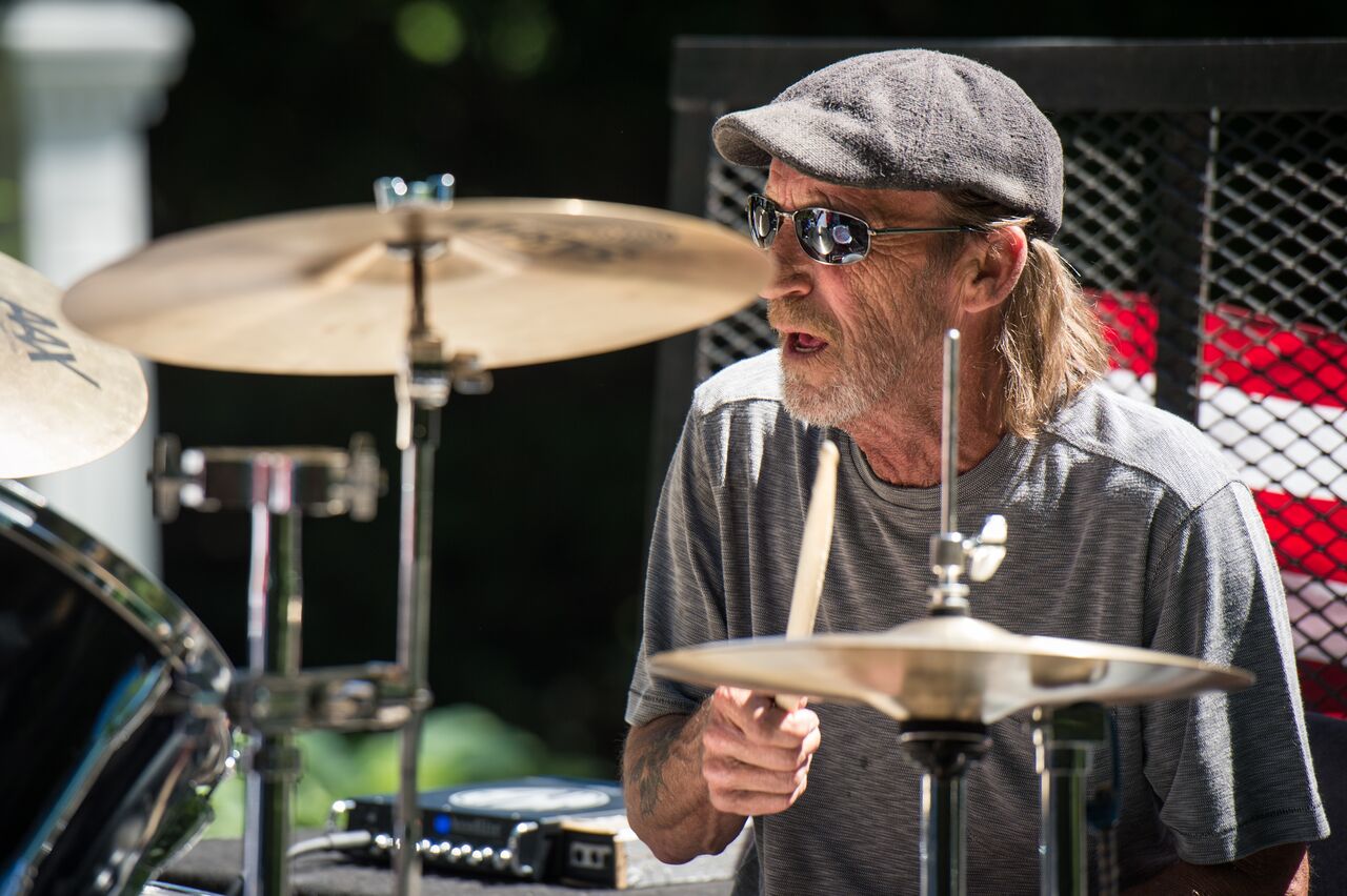 A person playing the drums during a 4th of July parade.