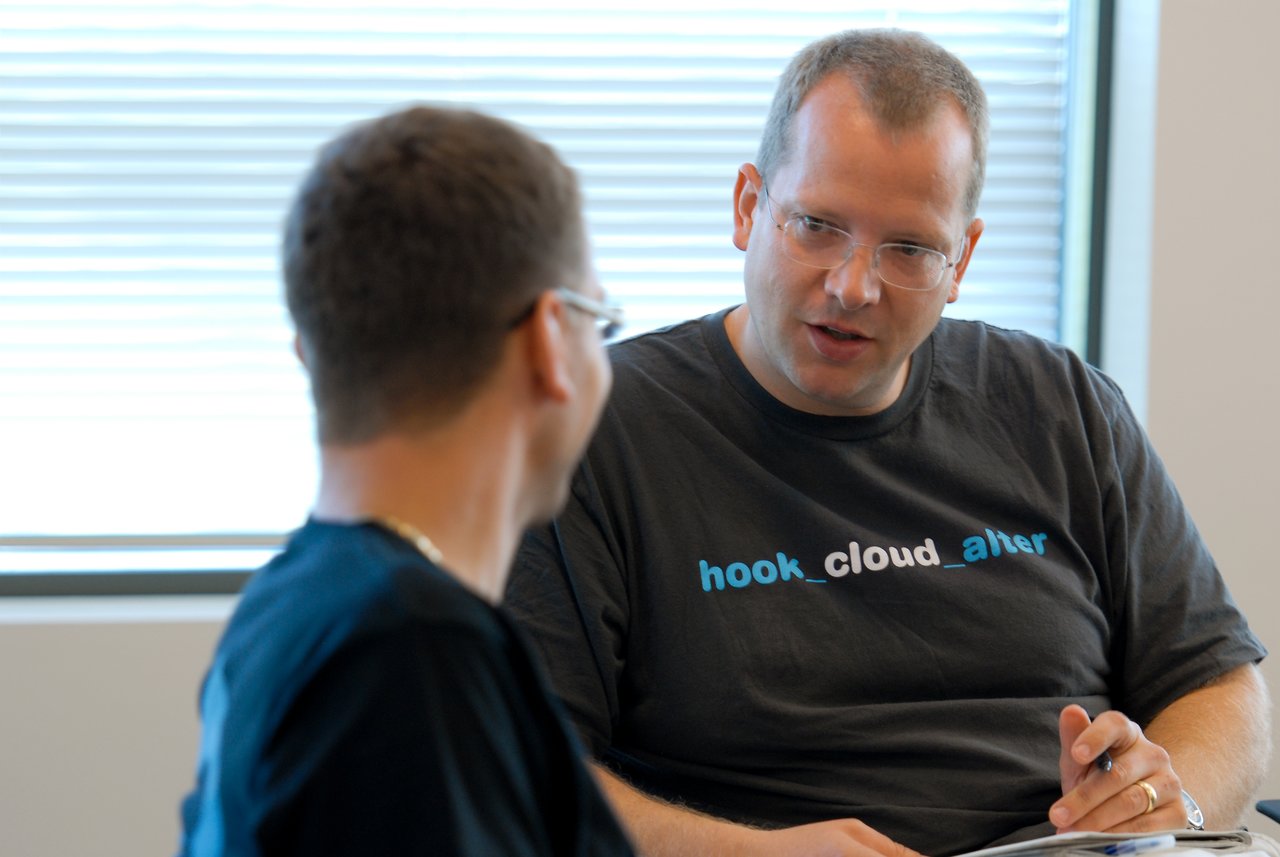 Two people are having a discussion in an office setting.