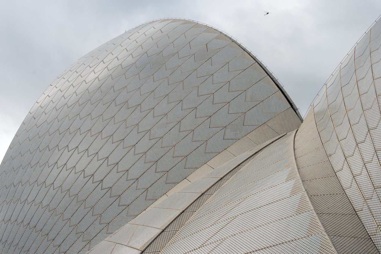 Close-up view of the Sydney Opera House roof, showing its curved, tiled surfaces.