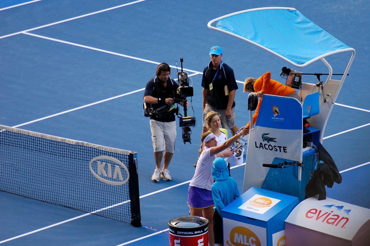A tennis player shakes hands with the chair umpire after a match at the Australian Open 2012.