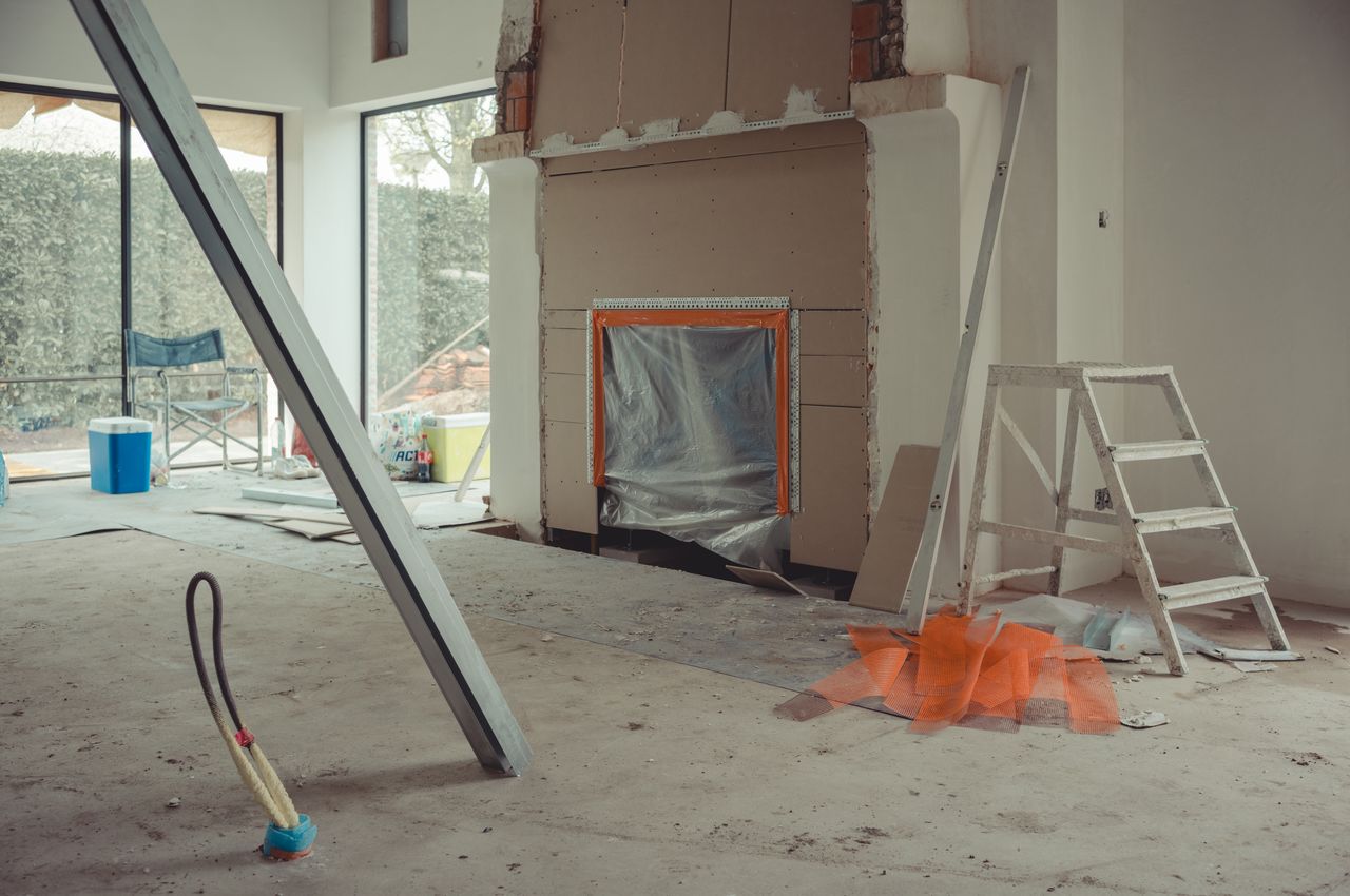 A fireplace with sheetrock around the opening.