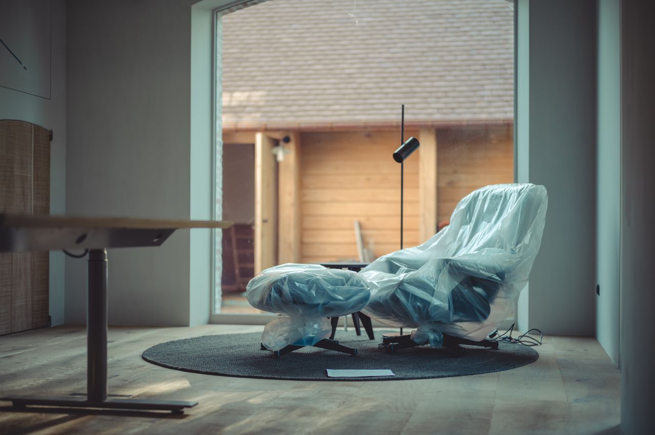 A plastic-wrapped lounge chair.