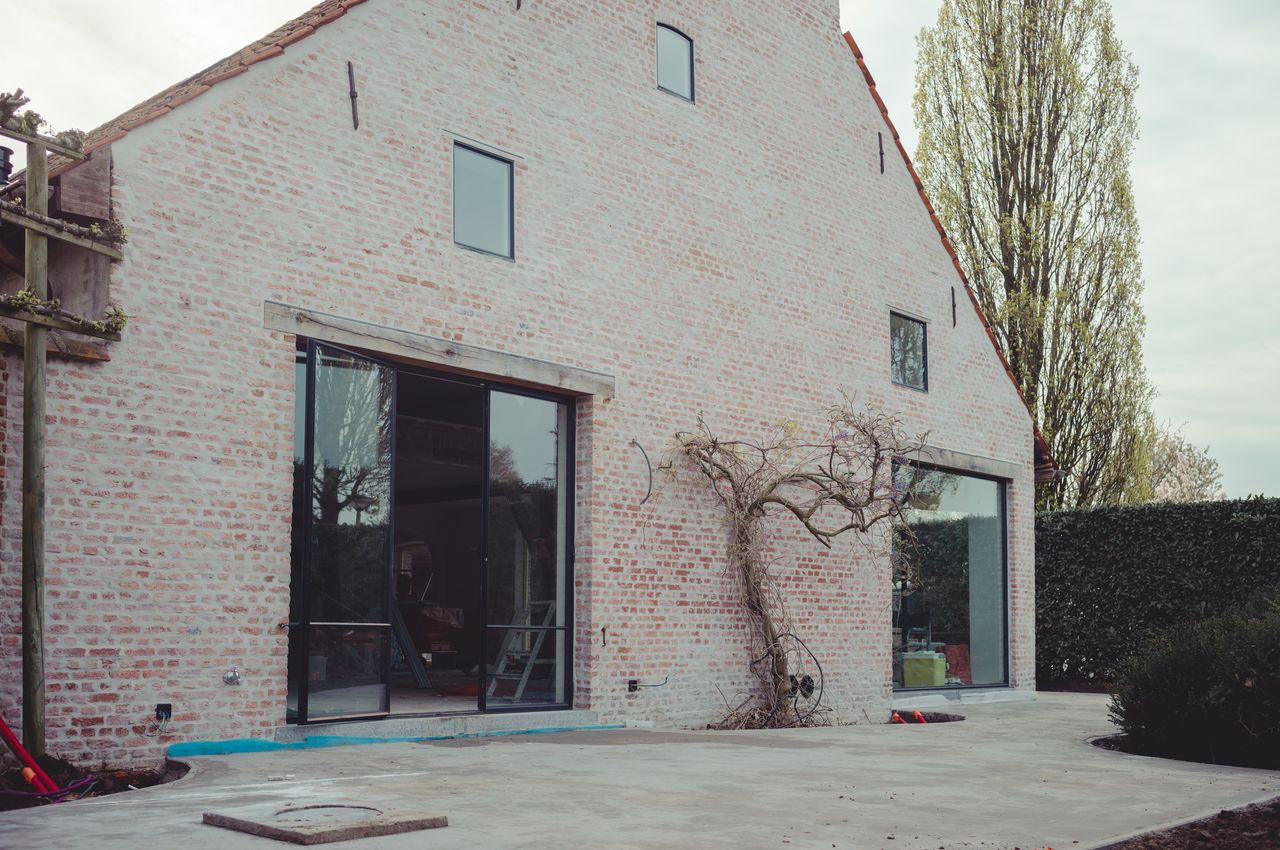 A brick house with a concrete terrace foundation.