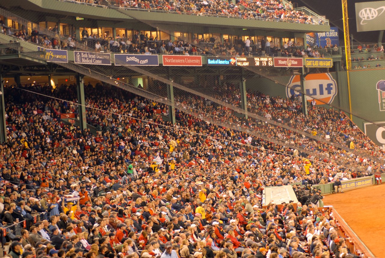 A large crowd of Boston Red Sox fans fills the stadium seats during a game at Fenway Park.
