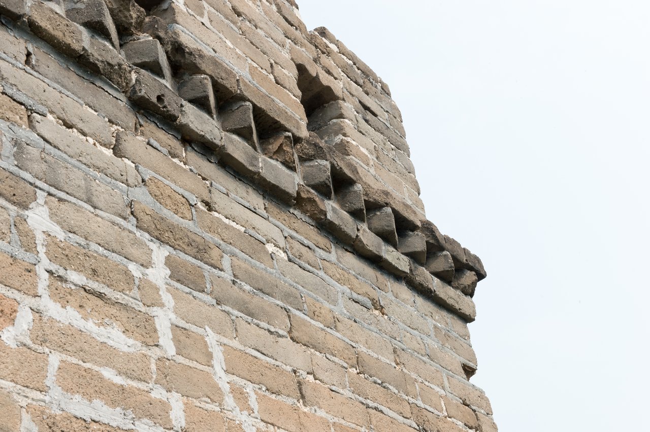 Close-up of a brick section of the Great Wall of China, showing detailed stonework and weathered edges.