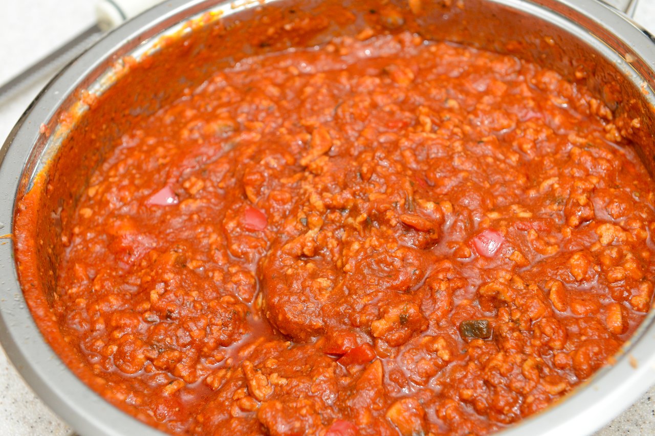 A pot of homemade spaghetti sauce with ground meat and diced vegetables, prepared for a Christmas 2012 meal.