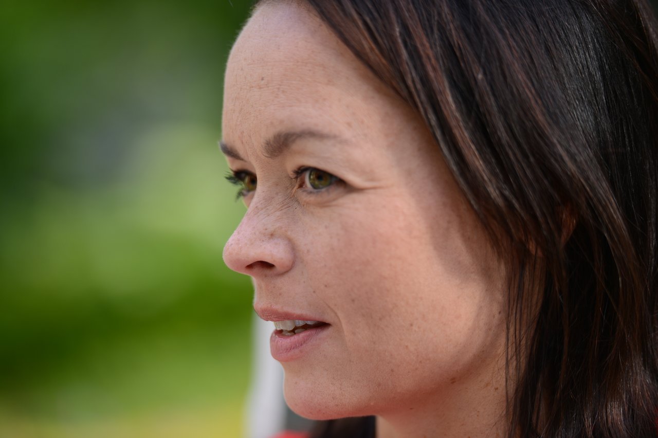 A woman attentively listens during a cooking class.