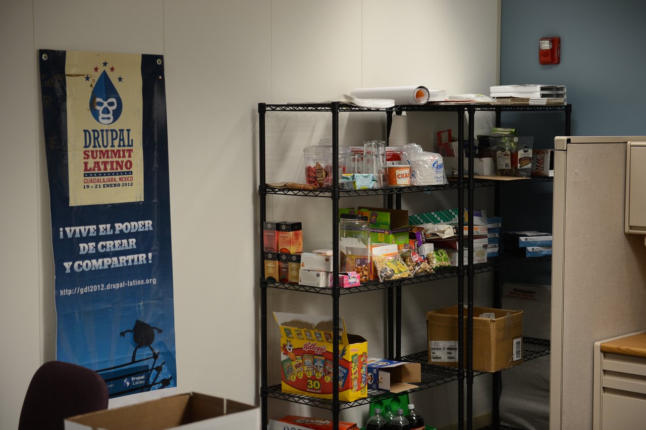 Office storage shelves with snacks, drinks, and supplies.