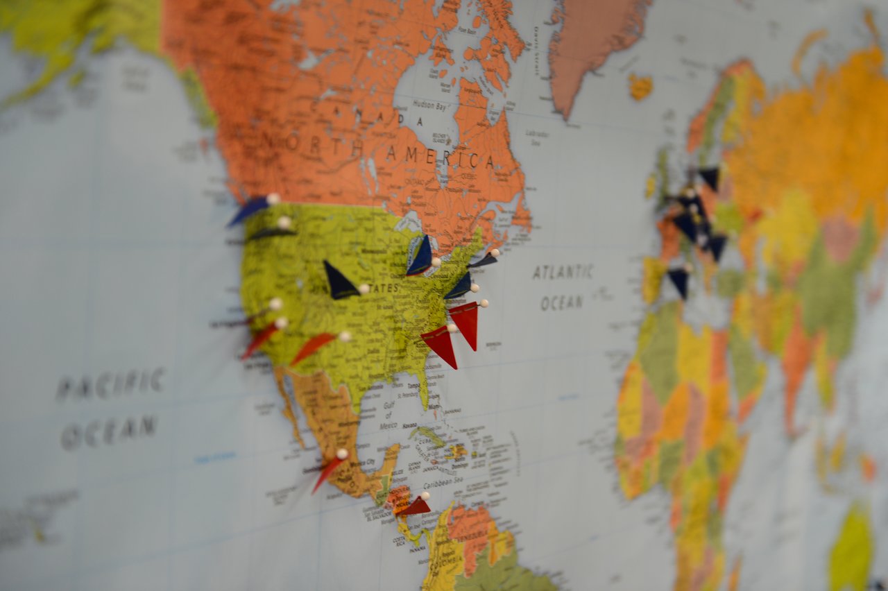 A world map with colorful pins marking various locations, likely representing Drupal Association connections or offices.