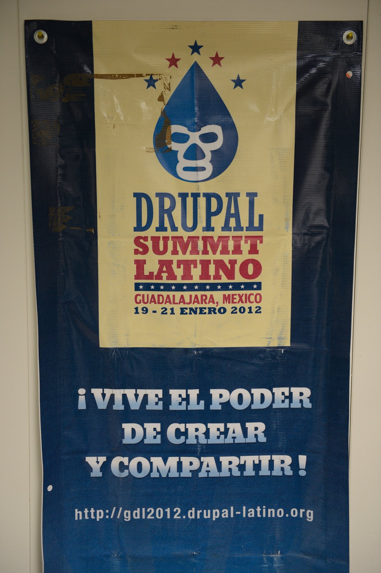 A banner for Drupal Summit Latino 2012 in Guadalajara, Mexico, featuring a Drupal logo with a luchador mask.