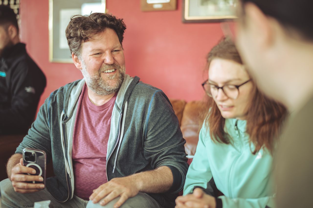 Portrait of a man sitting in a sofa.