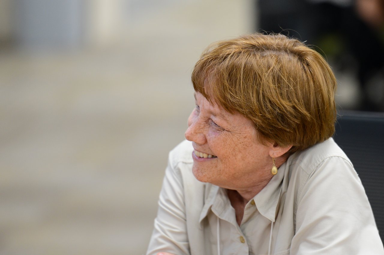 A person smiling and engaged in conversation at the Drupal Developer Summit Madison 2012 sprint event.