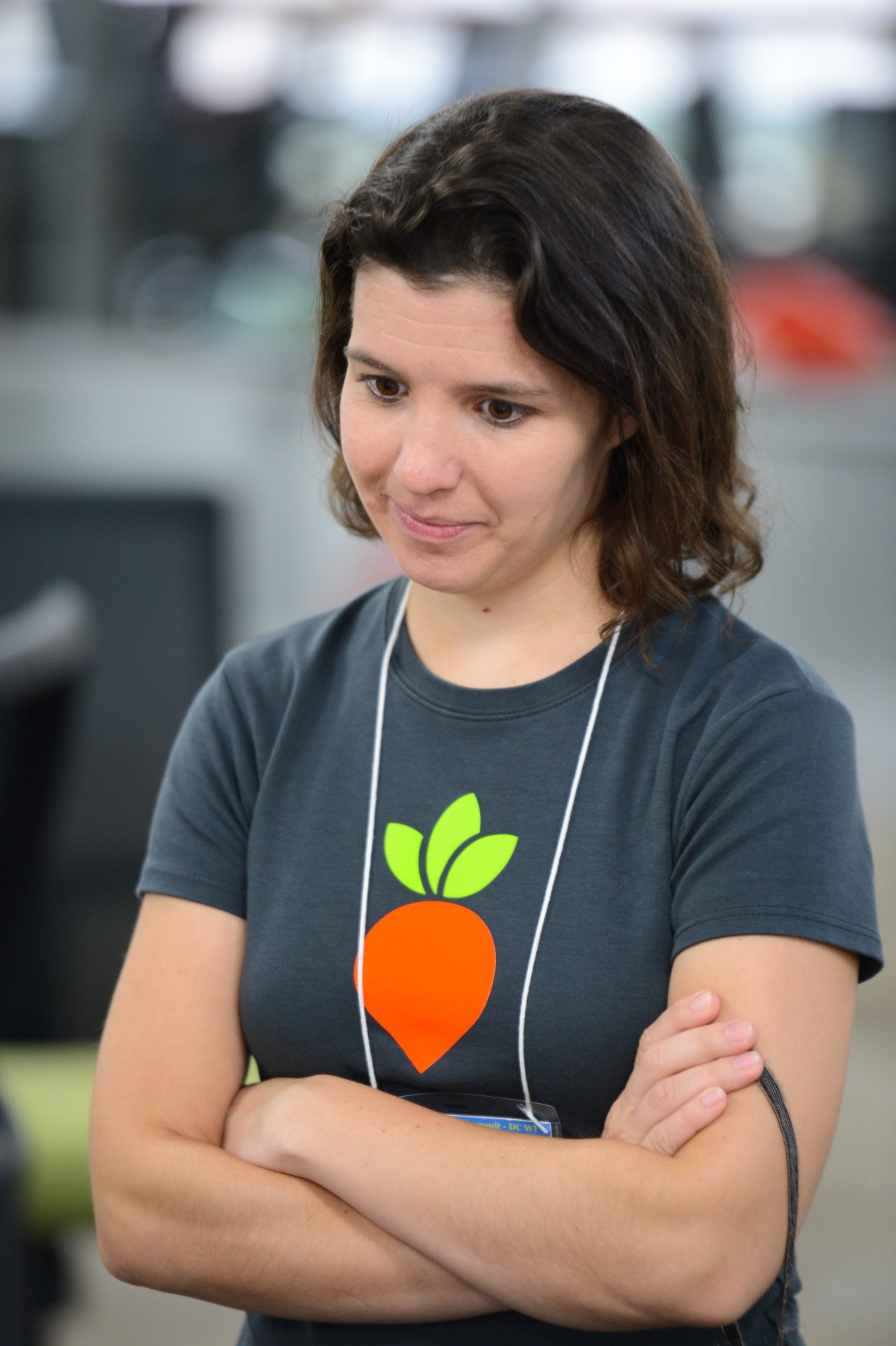 A person with crossed arms looks focused during the Drupal Developer Summit sprint event.