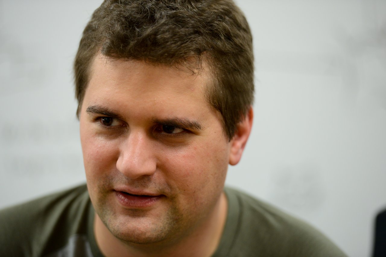 A person with short brown hair listens attentively during the Drupal Developer Summit sprint event.