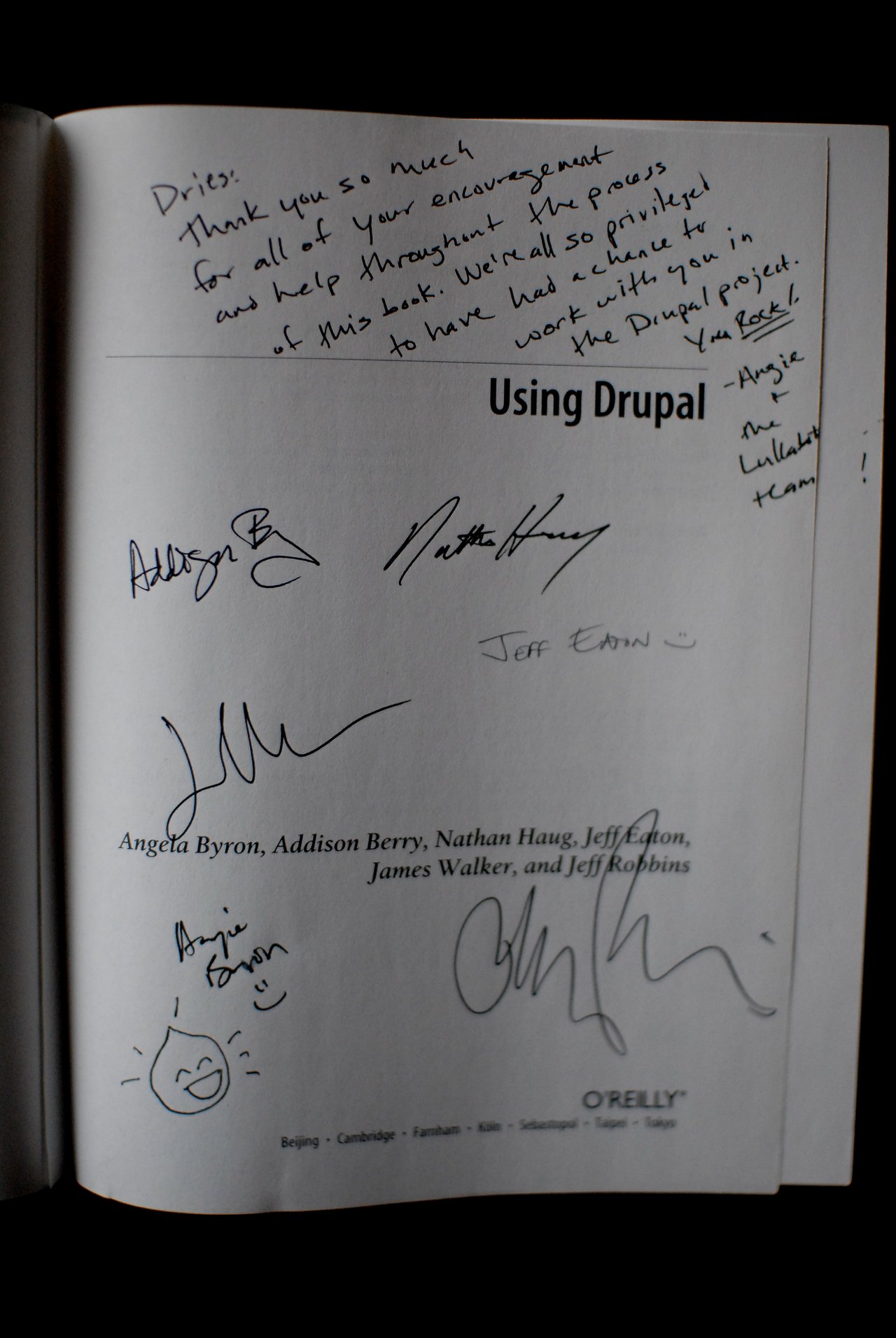 Title page of the book "Using Drupal" with handwritten messages and signatures from the authors.