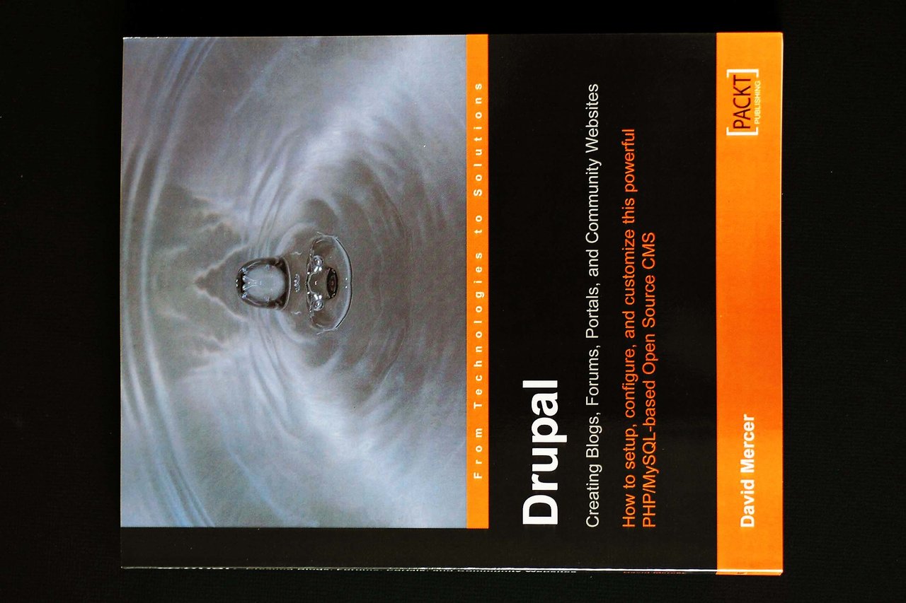 A Drupal book by Packt Publishing with a water droplet cover design and an orange and black color scheme.
