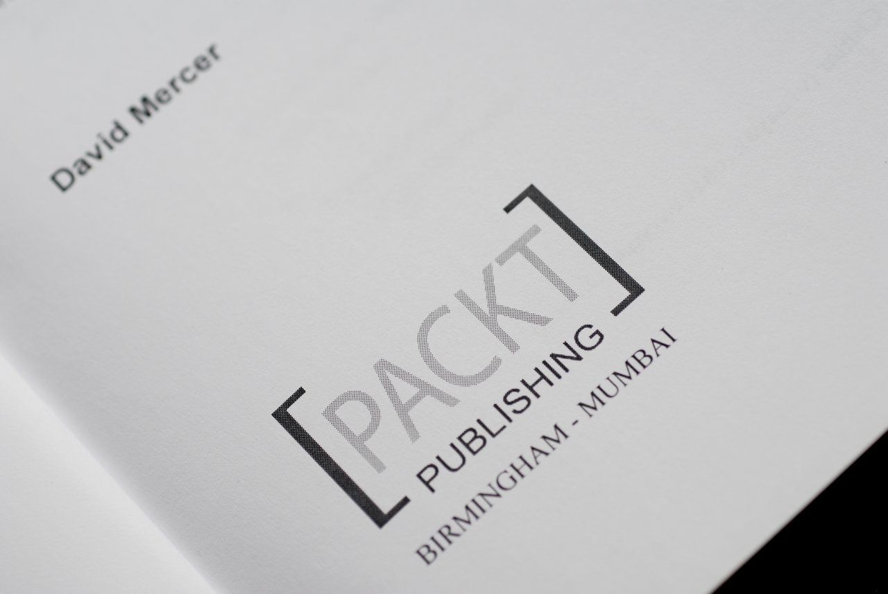 Close-up of a book page showing the author's name, David Mercer, and the Packt Publishing logo.