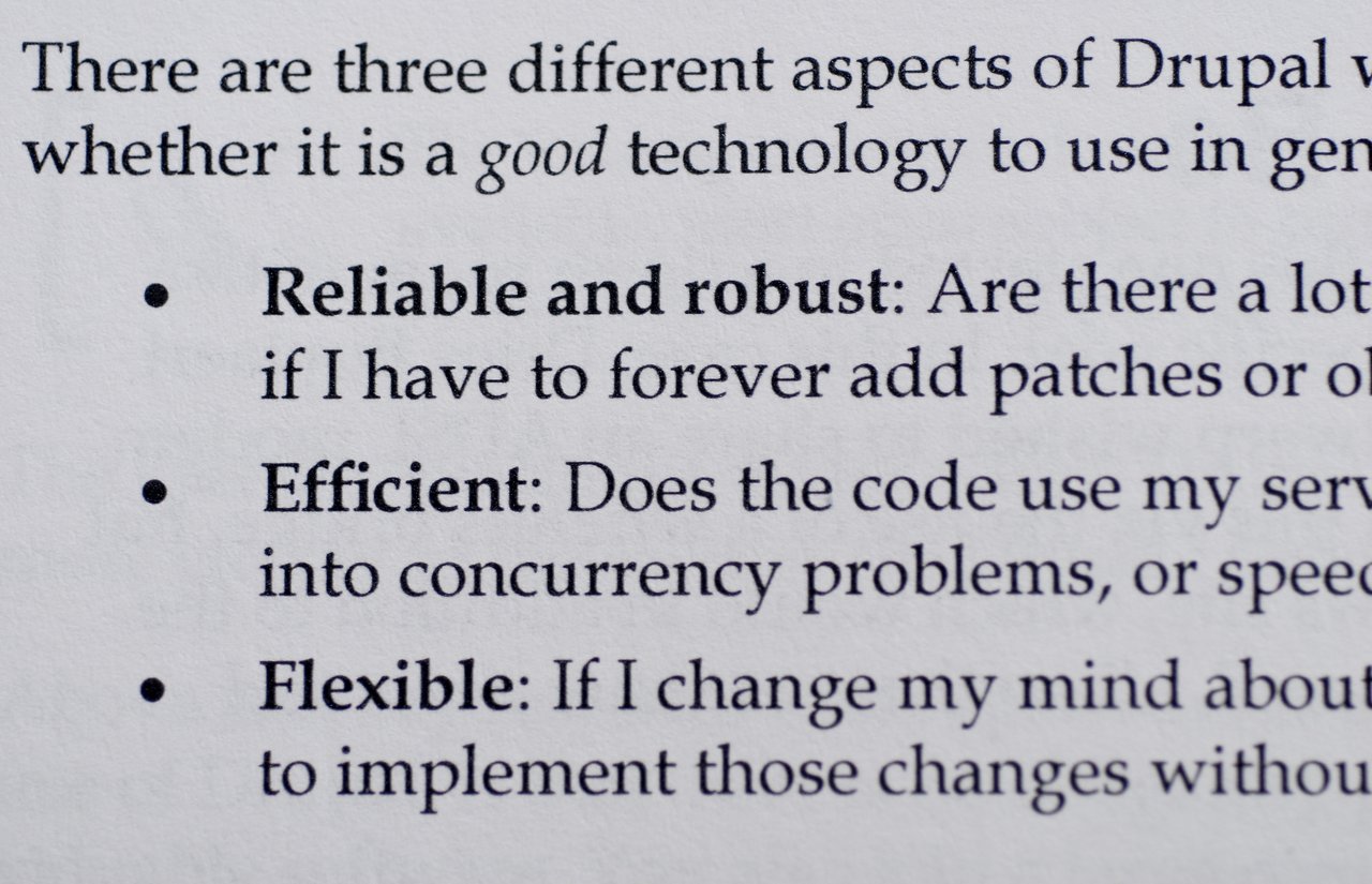 A book page discussing three key aspects of Drupal: reliability, efficiency, and flexibility in software development.
