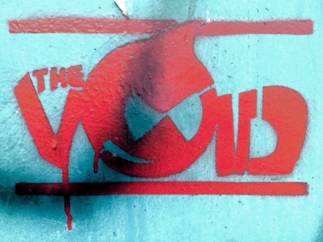 Red graffiti of an angry Druplicon face with the words "THE VOID" on a blue wall.