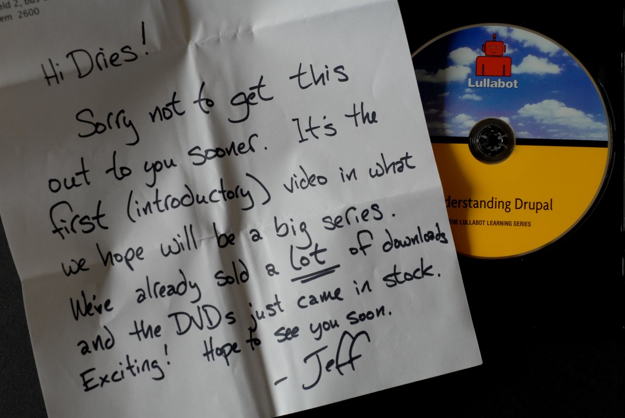 A handwritten note on paper next to a DVD labeled "Lullabot Understanding Drupal" in an open case.