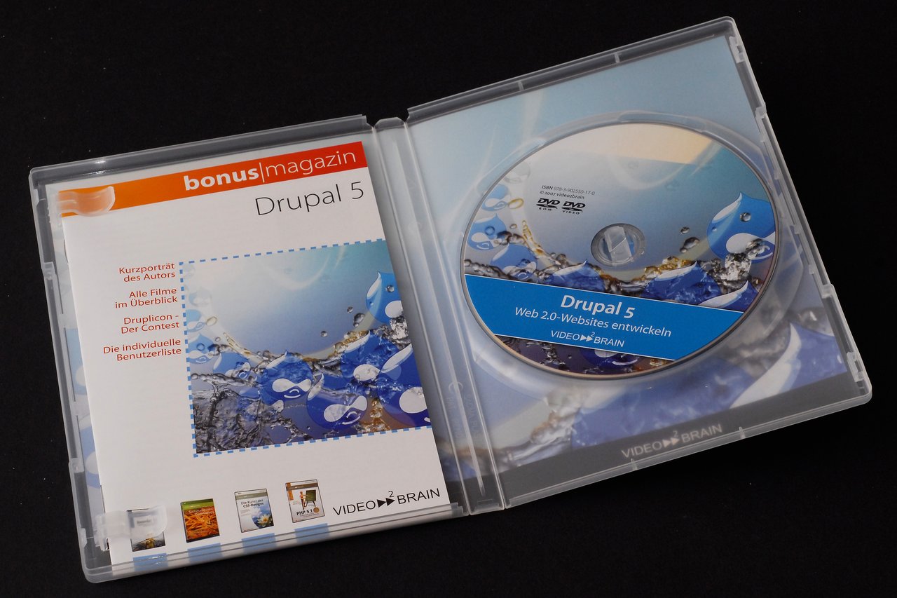 Open DVD case with a "Drupal 5" training disc and booklet from Video2Brain.