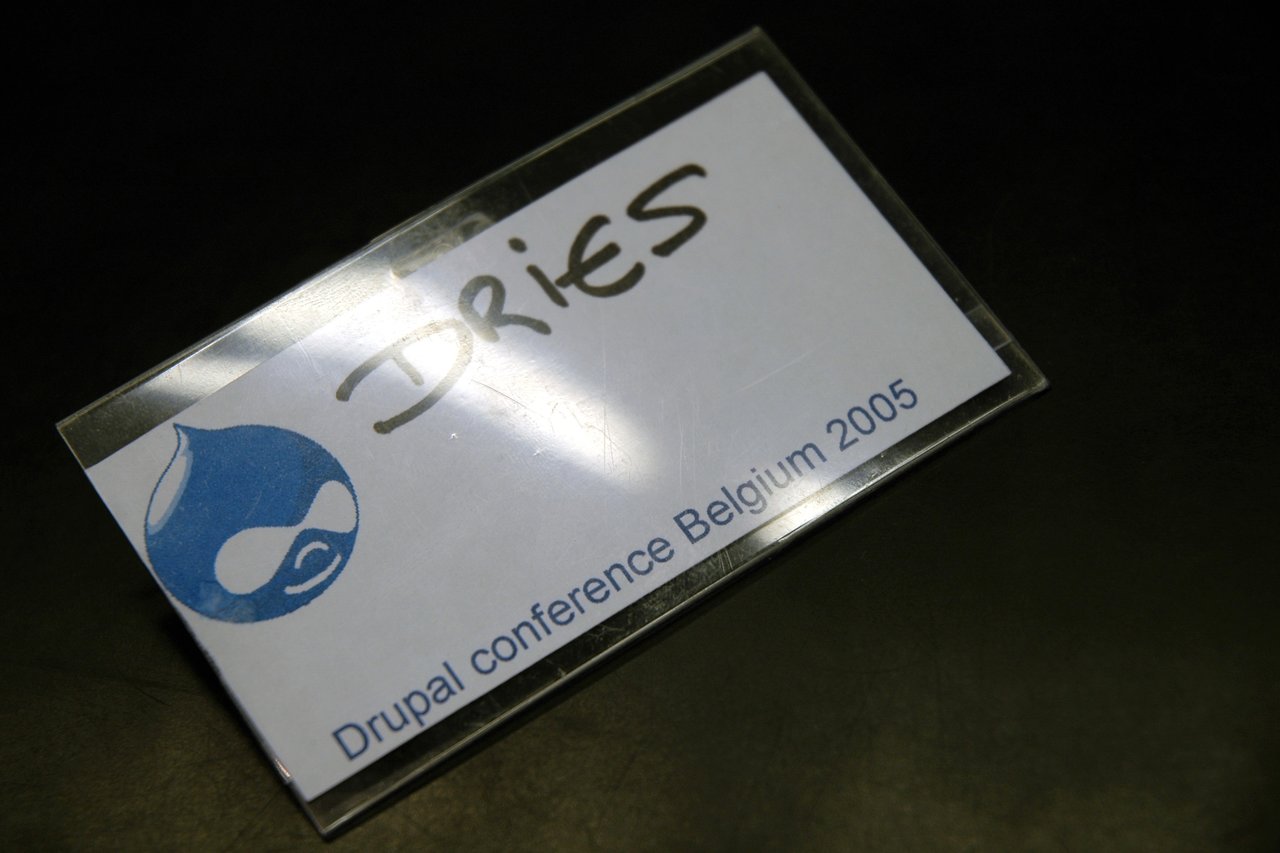 A name badge from Drupal Conference Belgium 2005, featuring a handwritten name and the Drupal logo.