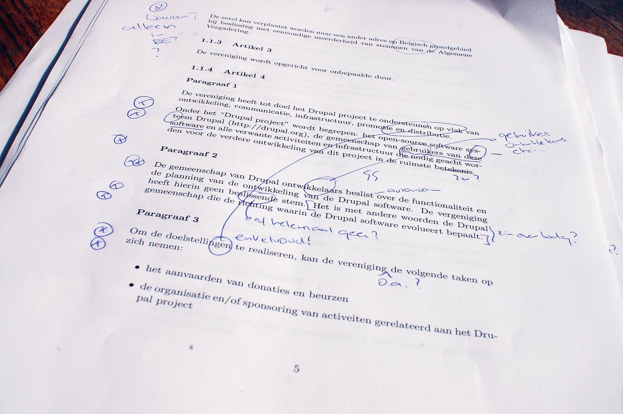 Printed document about the Drupal Association with handwritten annotations in blue ink questioning and clarifying its purpose and responsibilities.