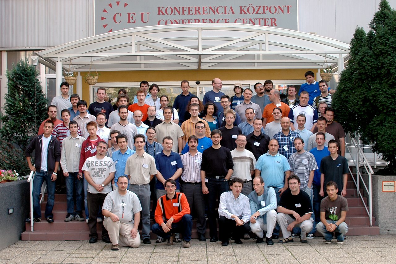 A large group of DrupalCon Budapest 2006 attendees posing for a group photo outside the conference center.