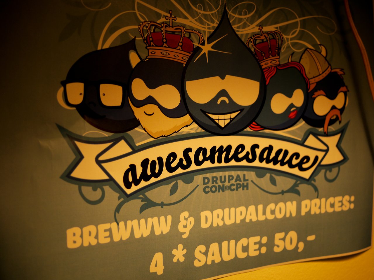 Poster with cartoon Drupal logos wearing crowns and sunglasses, featuring the text "awesomesauce" and DrupalCon Copenhagen pricing details.