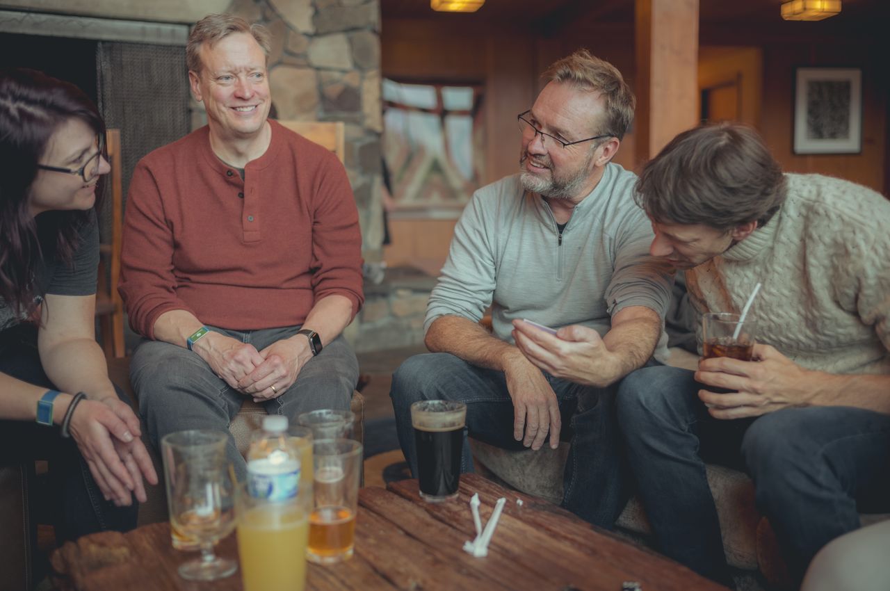 People seated around a table playing a board game.
