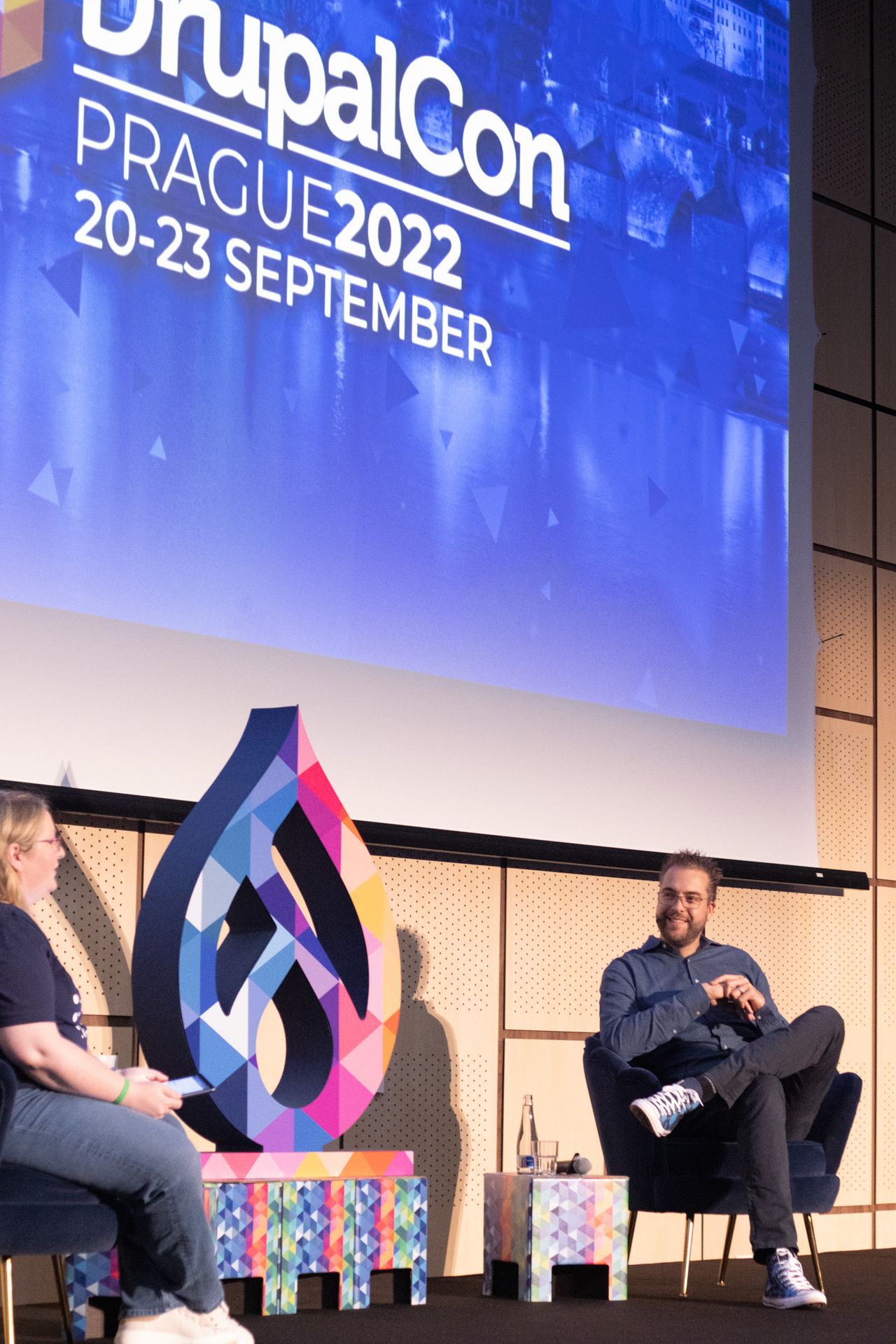 Dries sitting in a chair answering questions from the audience.