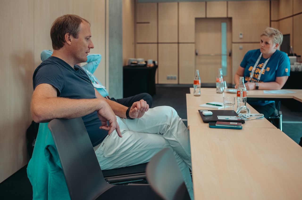Taavi Kotka sitting at a table in a meeting room