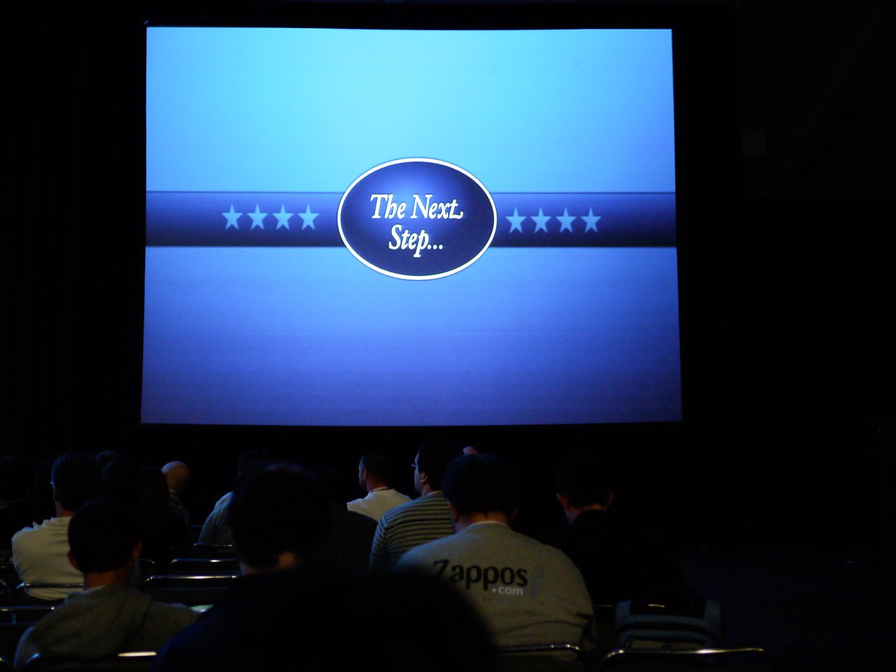 A presentation slide displays "The Next Step.