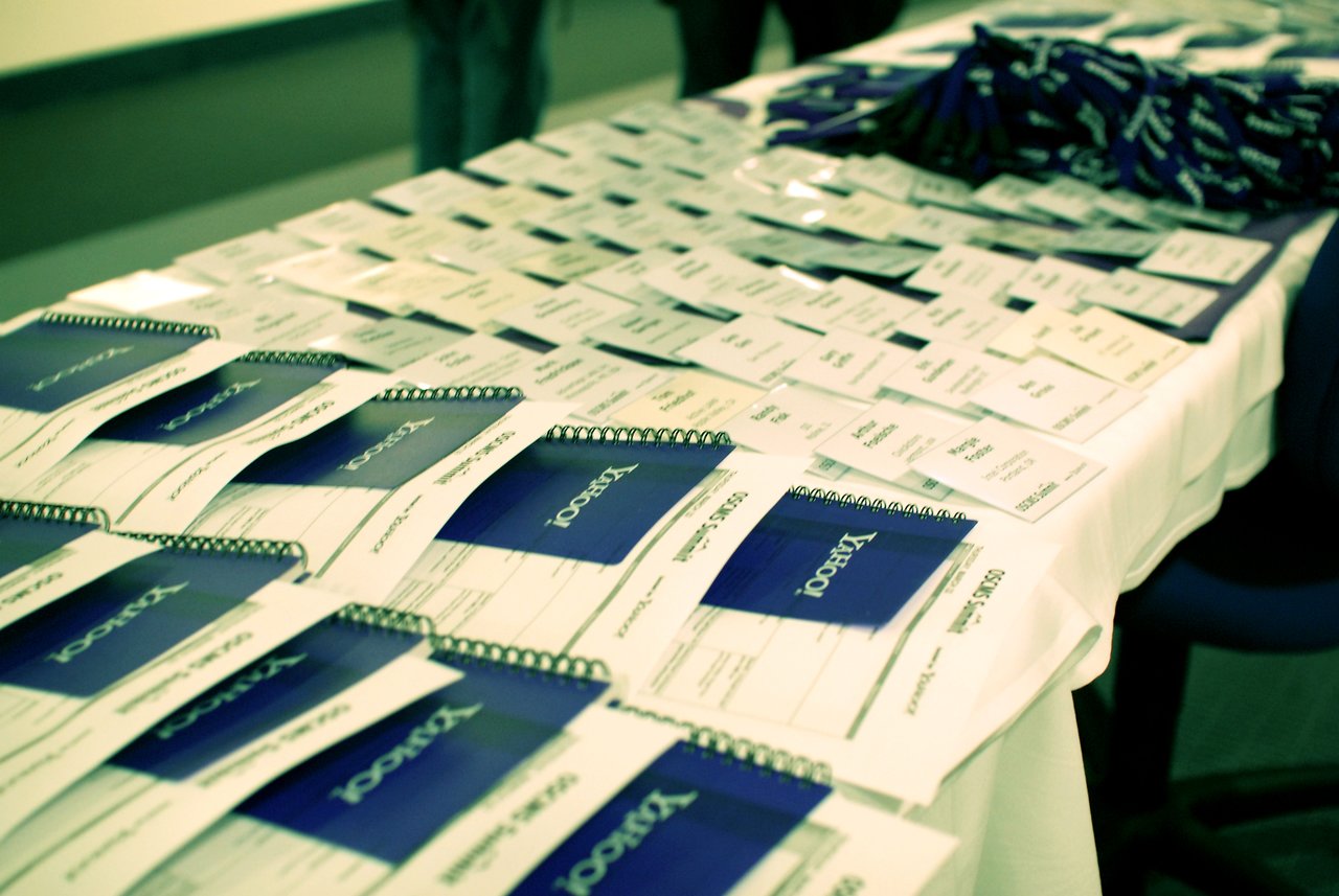 A table covered with Yahoo!-branded notebooks, name badges, and lanyards at DrupalCon Sunnyvale 2007.