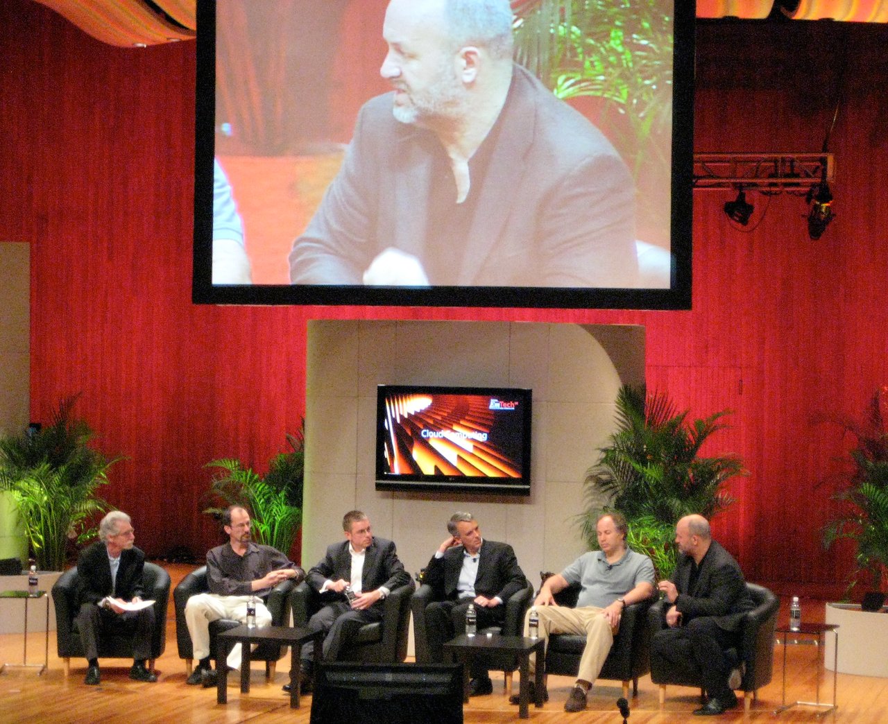 A panel of six experts discusses cloud computing on stage at the EmTech 2008 conference.