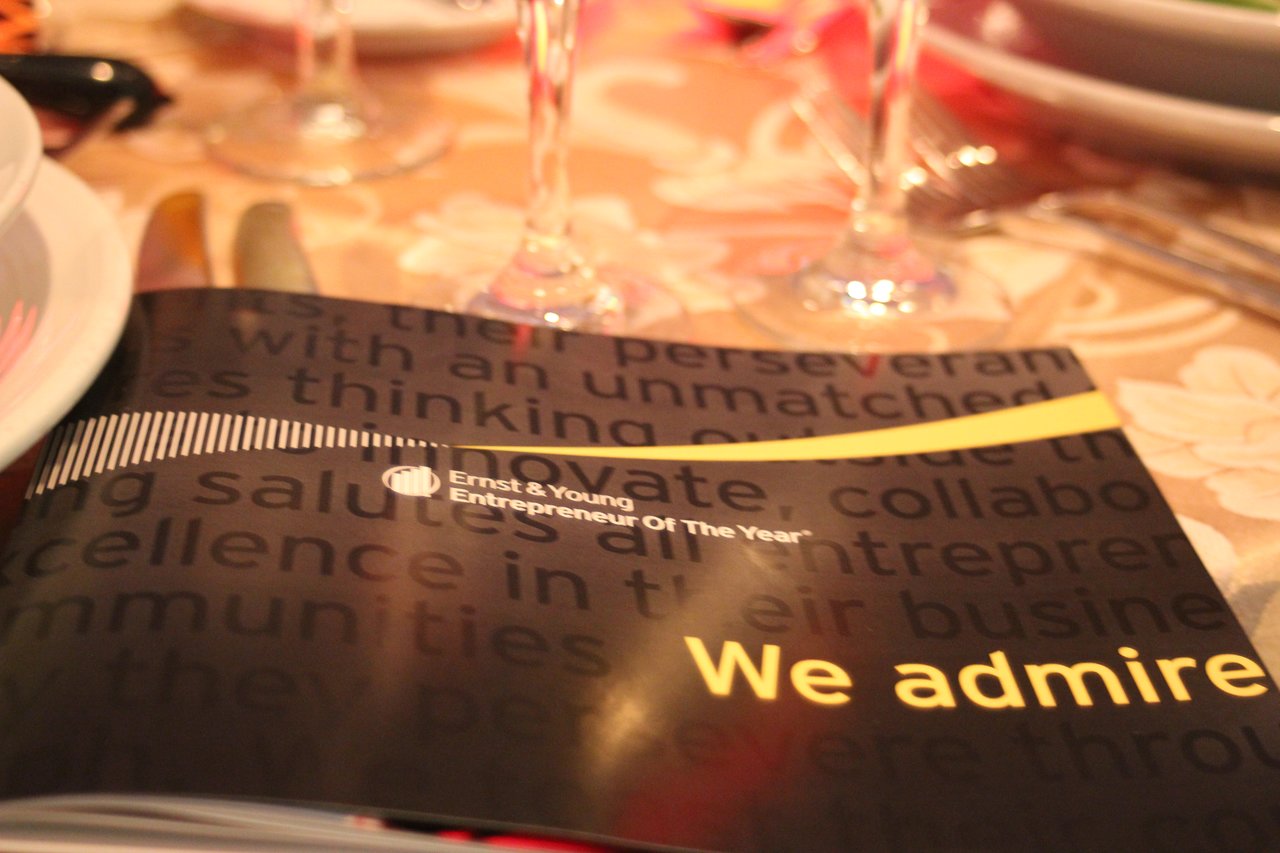 A program booklet for the Ernst &amp; Young Entrepreneur of the Year award rests on a banquet table.