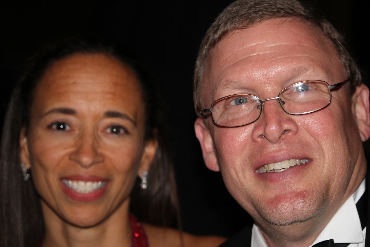 A man and woman smile at the camera during the Ernst &amp; Young Award banquet in New England, 2012.