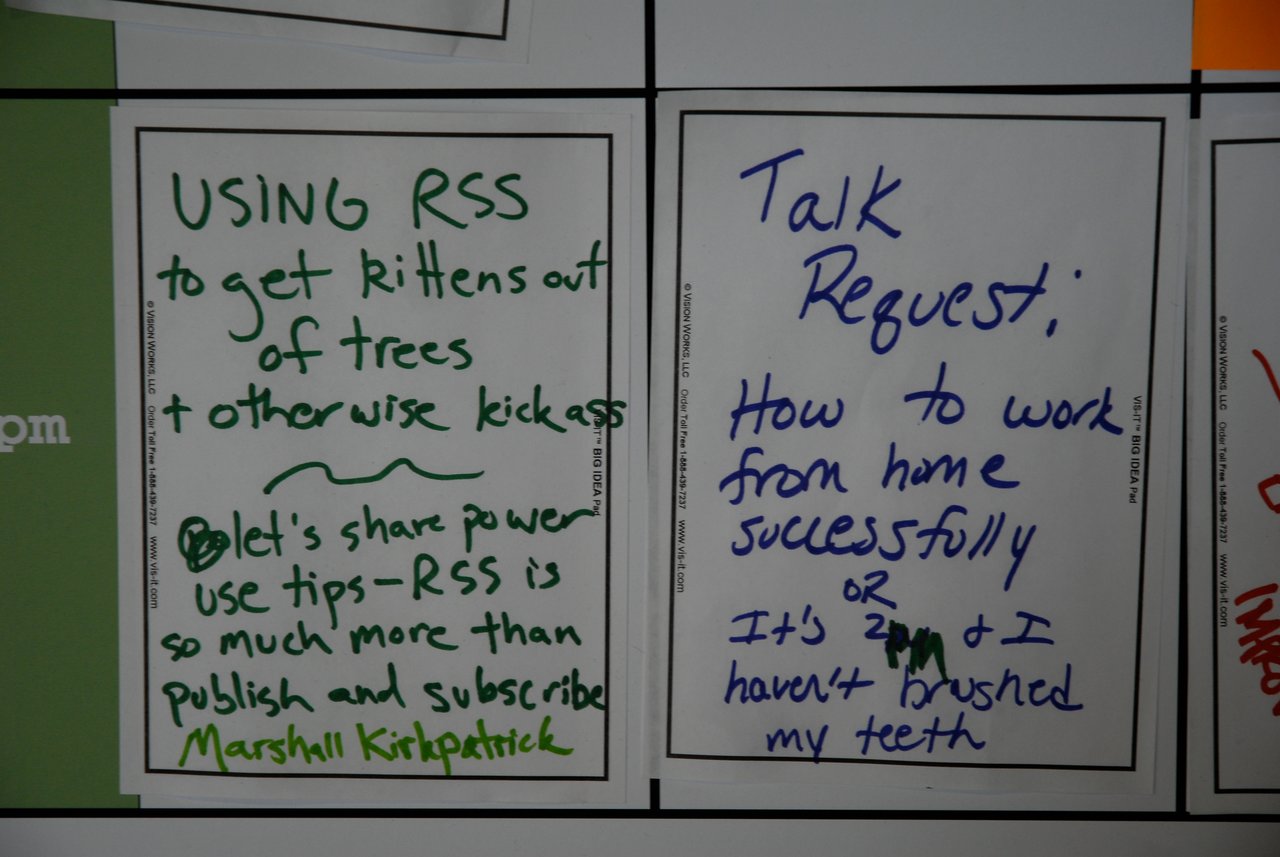 Two handwritten notes on a board suggest discussion topics: using RSS creatively and tips for working from home successfully.