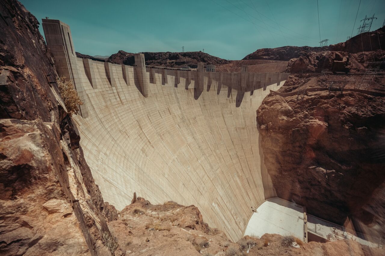 A large concrete dam spanning a deep canyon.