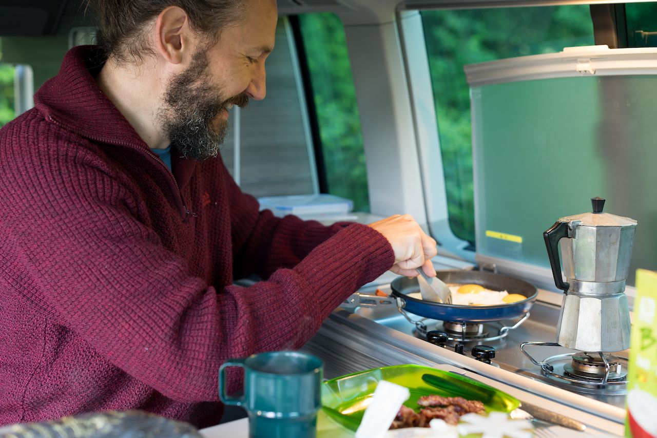 Klaas making breakfast in his Volkswagen California