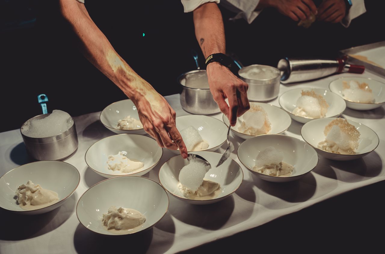 Chefs carefully plate "Five Ages of Parmigiano Reggiano" at Francescana at Maria Luigia, a three-Michelin-star restaurant.