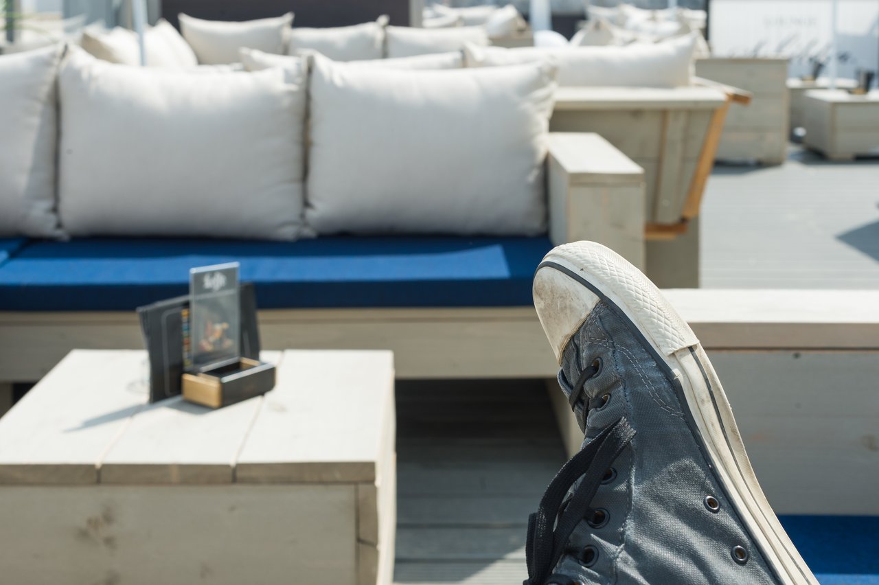 A person's foot in a worn black sneaker.