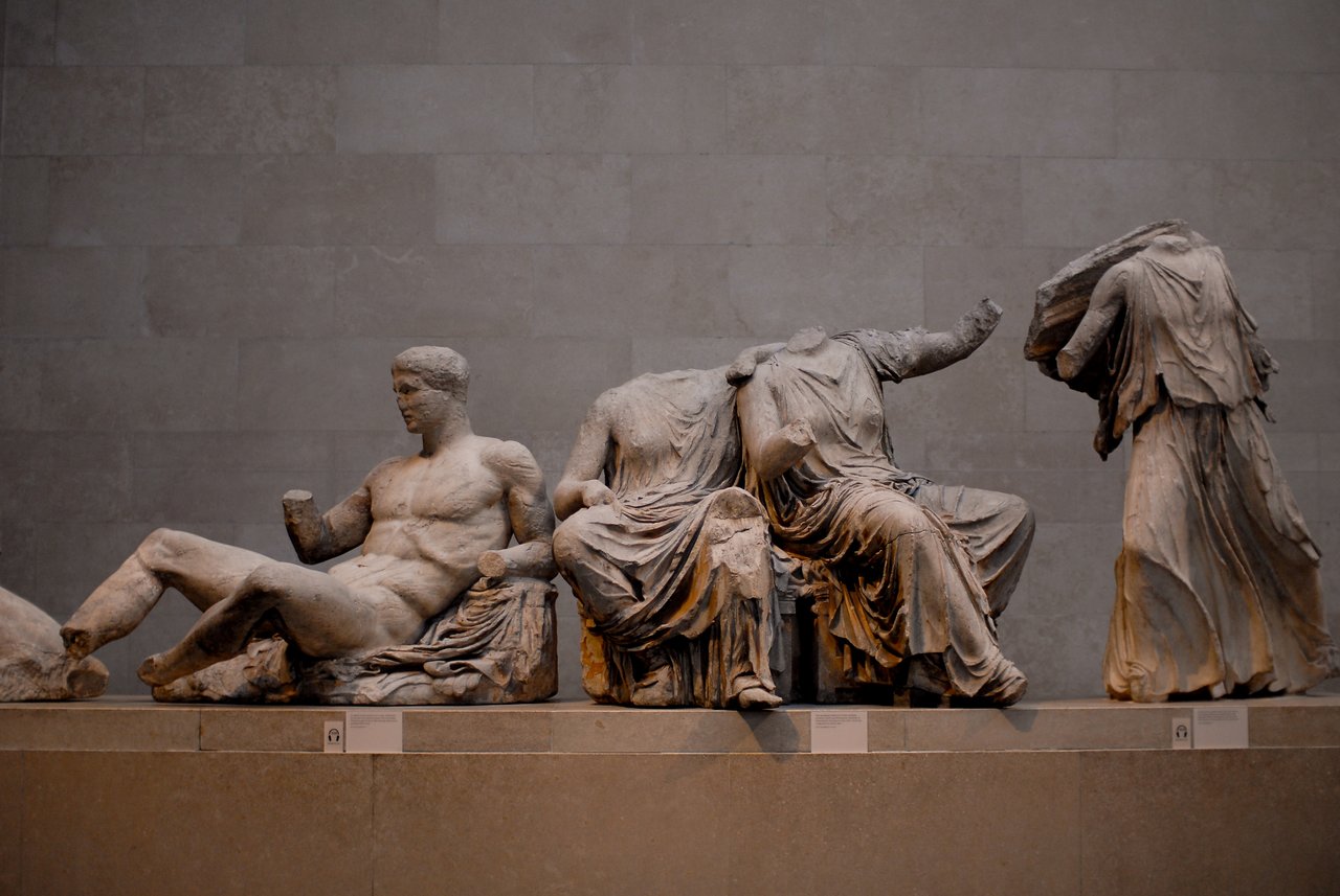 Ancient marble sculptures from the Parthenon's east pediment, depicting reclining and seated figures with missing heads and limbs.