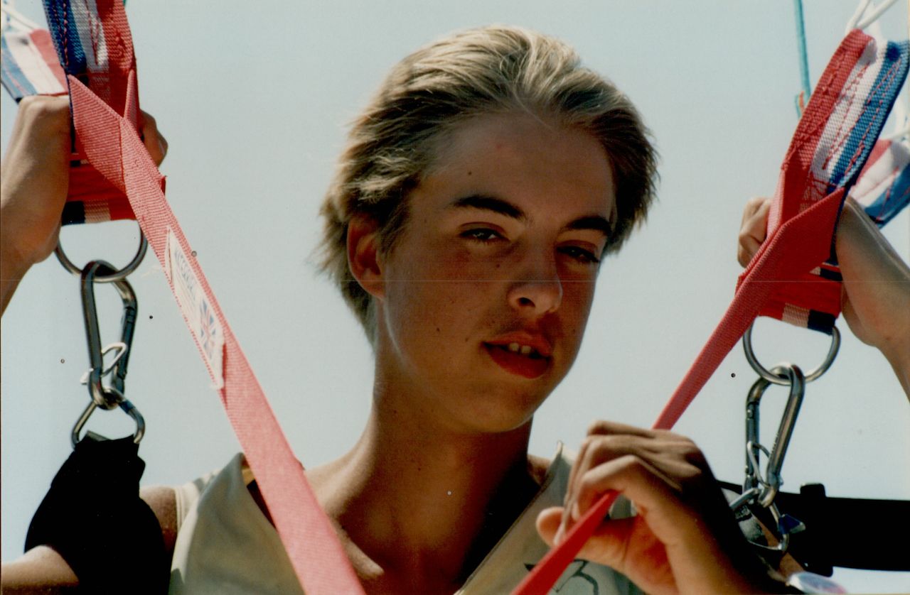 A 15-year-old holding onto red harness straps, preparing for an outdoor activity in Turkey.