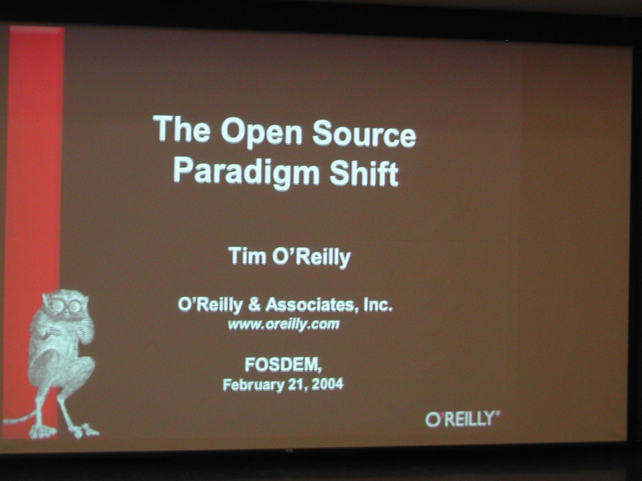 A presentation slide at FOSDEM 2004 titled "The Open Source Paradigm Shift" by Tim O'Reilly.