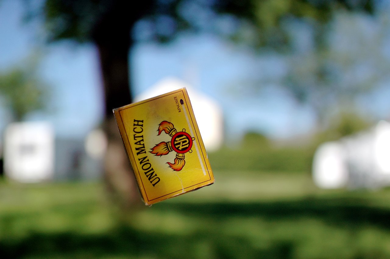 A yellow "Union Match" box is captured mid-air, appearing to be falling outdoors.