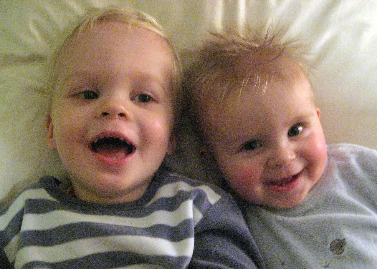 Axl and Stan laying next to each other laughing.