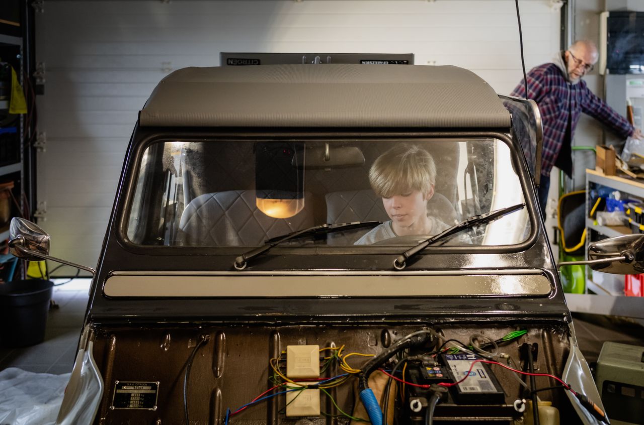Stan sitting behind the steering wheel of Opa's Citroën 2CV.