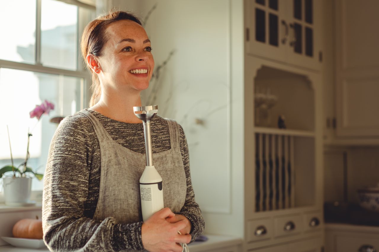 Vanessa holding a blender.