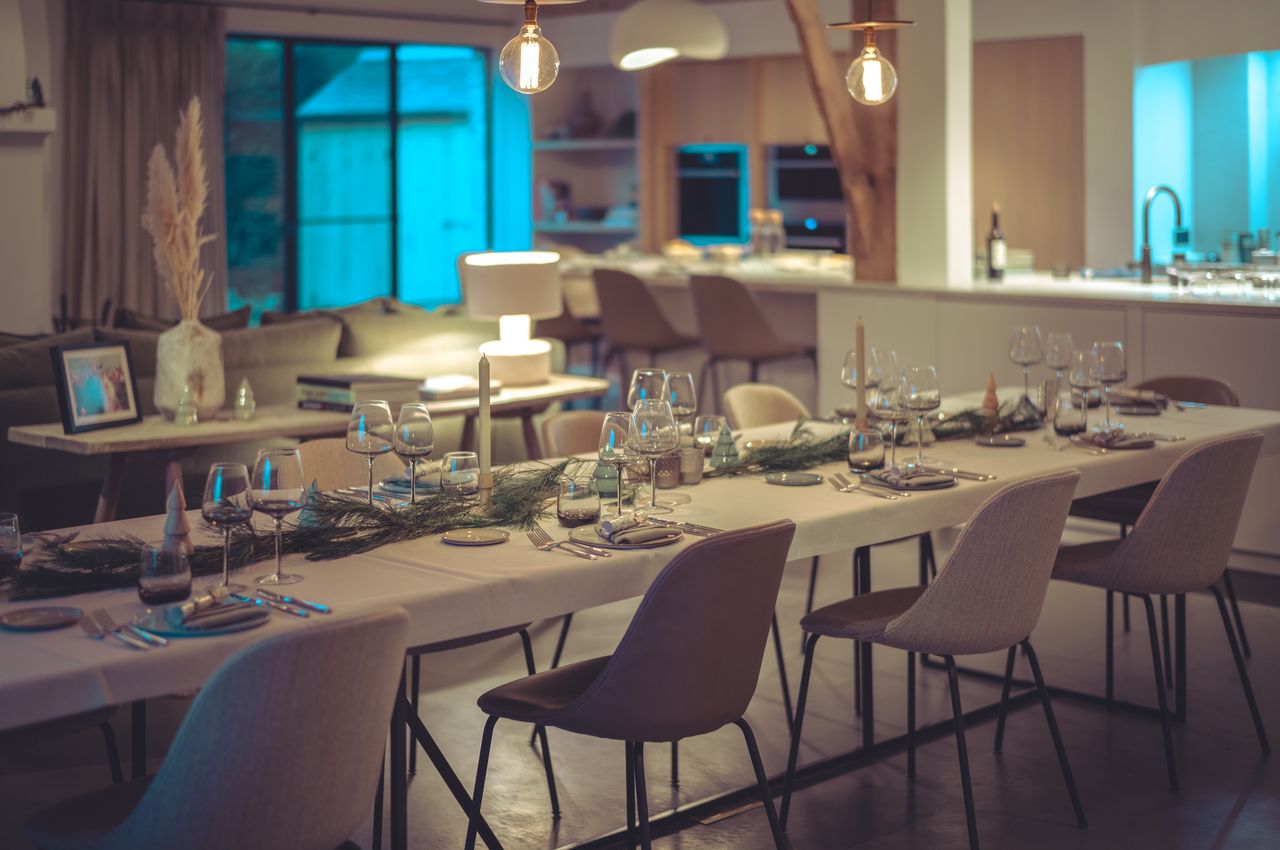 A table decorated with candles, pine branches and Christmas holiday ornaments.